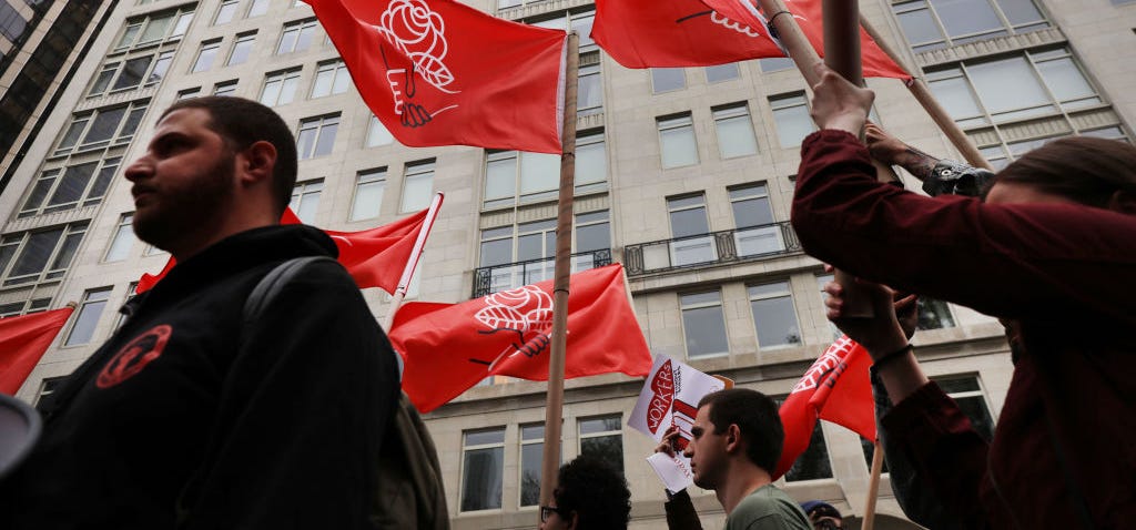 Members of the Democratic Socialists of America gather outside of a Trump-owned building on May 1, 2019, in New York City.