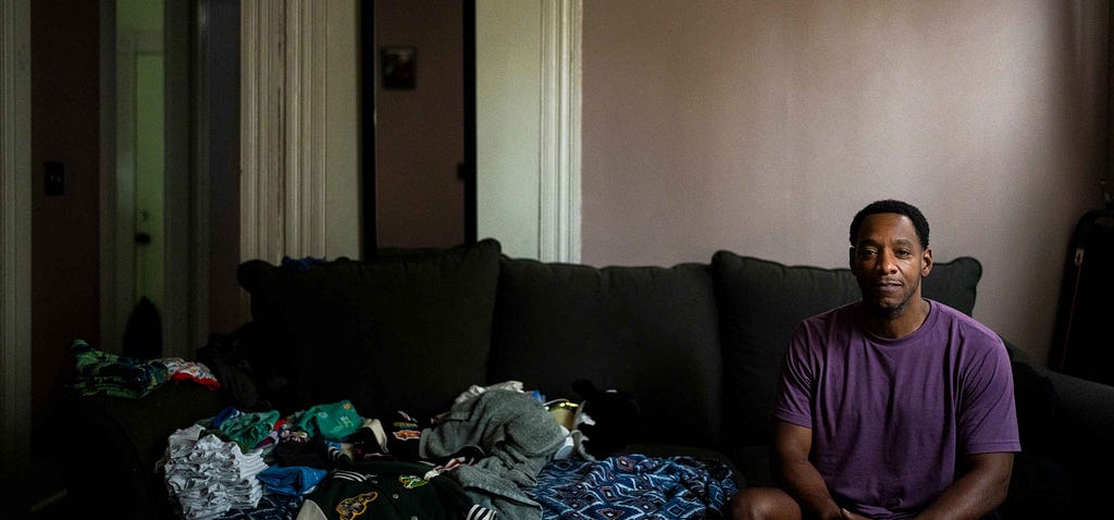 Michael White sits for a portrait after being accepted into New Haven’s guaranteed income program.